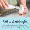 Tommee Tippee Essentials Bottle Brush with soft nylon bristles, demonstrating hygienic cleaning on a bottle.