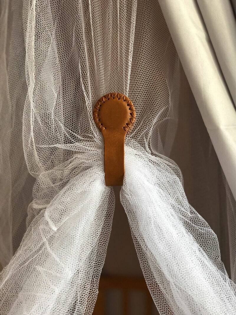 The Stella Clip in Beach Bébé securely holds sheer fabric, featuring a stylish leather loop with cream stitching.