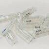 BIBS Glass Bottle 225ml, clear with measurement markings, arranged in a scattered layout on a light background.