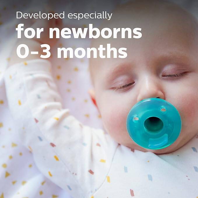 Philips Avent Newborn Soothie in green, designed for infants 0-3 months, shown with a sleeping baby.