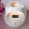 Spectra S2 Plus Double Electric Breast Pump in white and pink with a digital display and control buttons, set on a pink