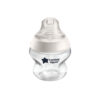 Tommee Tippee clear baby bottle with a white lid, featuring a star logo, designed for easy feeding and comfort.