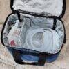 Spectra Handsfree Cup Set in a blue insulated bag, featuring tubing and ice packs, ideal for on-the-go breastfeeding.