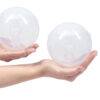 Spectra Handsfree Cup Set in clear, held in two hands, showcasing the 24mm and 28mm sizes for breast pumping.