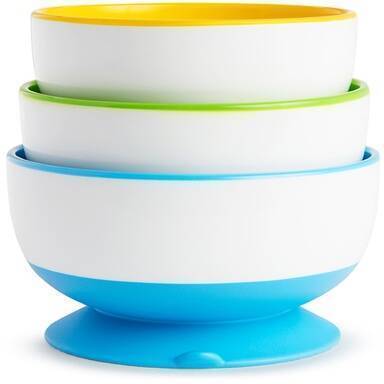 Munchkin Stay Put Suction Bowls in purple, green, blue, and yellow with a sturdy suction base for mess-free feeding.