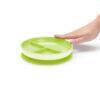 Munchkin Stay Put Suction Plate in vibrant green, featuring three divided sections and a strong suction base.