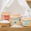 Eco Boom Joy Bamboo Baby Nappies in eco-friendly packaging displayed in a cozy nursery setting with a woven basket.