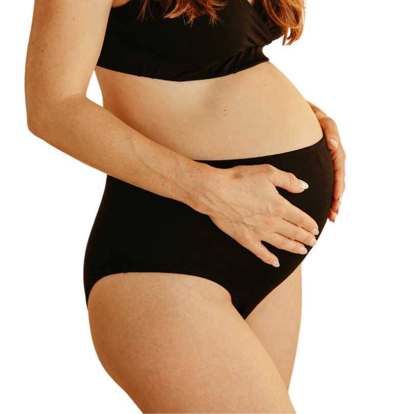 myboombra® high-rise underwear in black, designed for comfort during pregnancy, shown on a woman cradling her belly.