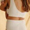 myboombra® bamboo nursing and maternity bra in white, worn by a mother holding her baby, showcasing the back design.