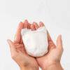 My Little Prem Micro Preemie Nappies held in two hands, showcasing their small size and soft, white material.