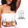 Medela Hands-Free Pumping Bustier in white, size L, worn by a woman with curly hair, showing dual pump setup without breast