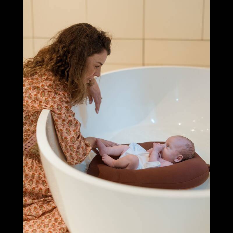 Little Bear Baby Bath Lilo in Duck Egg Blue, cradling a baby in a modern bathtub with a mother interacting lovingly.