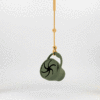 Maccie Anti-Drop Chain in beige features a stylish bucket design with a black spider motif, ideal for securing accessories.