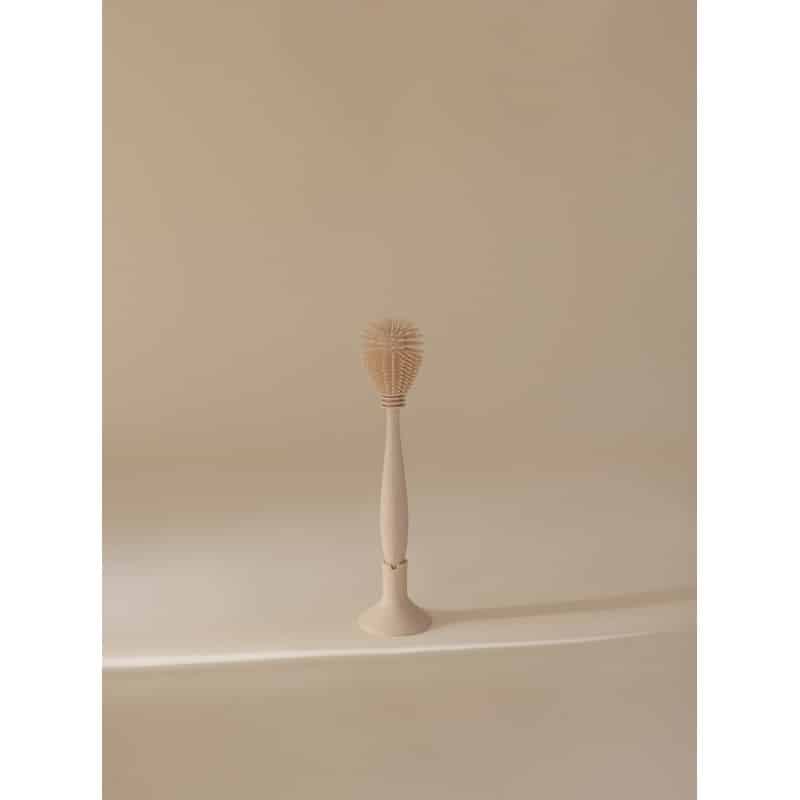 Mushie Silicone Baby Bottle Brush in Shifting Sand, featuring a soft silicone bristle head and a sleek handle.