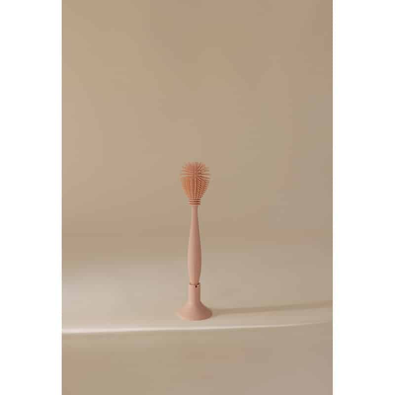 Mushie Silicone Baby Bottle Brush in blush, featuring a flexible bristle head for effective cleaning.