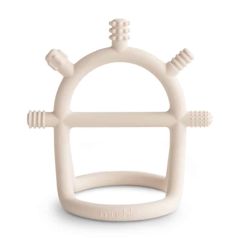 Mushie No-Drop Sensory Teether in Blush and Shifting Sand with textured grips for soothing gums.