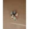 Mushie Silicone Fresh Food Feeders in blush, Cambridge blue, sage, and shifting sands arranged on a neutral background.