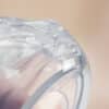 Haakaa Shell Wearable Silicone Breast Pump in clear silicone, showcasing a close-up detail of the unique design.