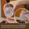 Haakaa Shell Wearable Silicone Breast Pump being cleaned under running water, showcasing its flexible design and easy