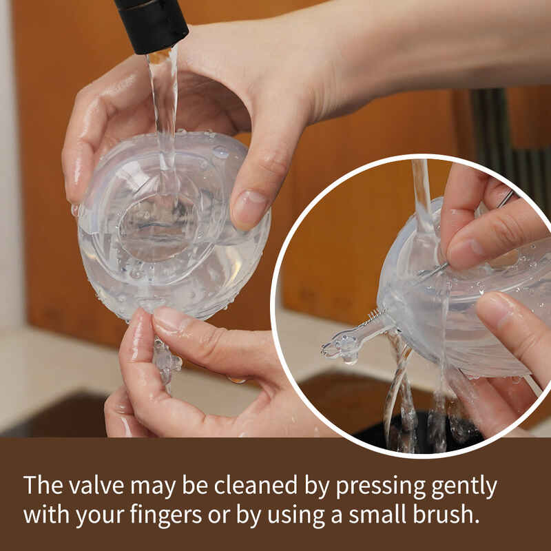 Haakaa Shell Wearable Silicone Breast Pump being cleaned under running water, showcasing its flexible design and easy