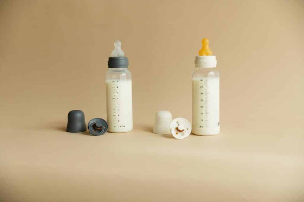 BIBS SS25 baby bottle collection featuring two bottles with different colored nipples and caps, set against a neutral