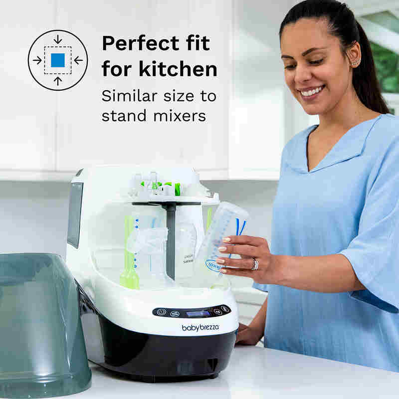 Baby Brezza Bottle Washer Pro in a kitchen setting, with a woman using it to clean baby bottles. Compact and sleek design.