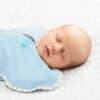 Love to Dream Swaddle Up in mint green stars, featuring a zip closure and soft fabric, shown on a sleeping newborn.