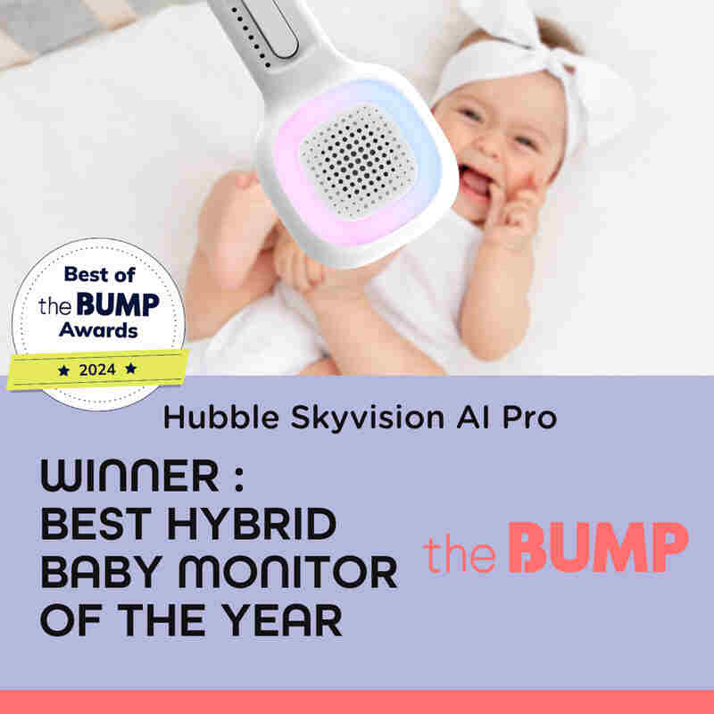 Hubble Skyvision AI Pro baby monitor with a smiling baby, showcasing the monitor's design and award badge for Best Hybrid