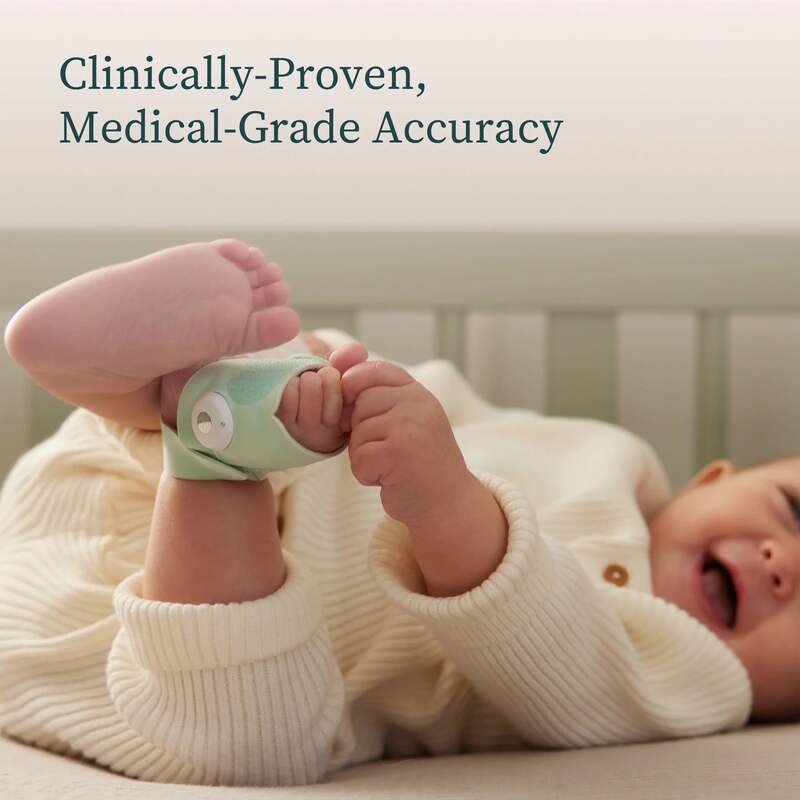 Owlet Dream Sock in mint green on a baby's foot, showcasing its medical-grade accuracy in a cozy nursery setting.