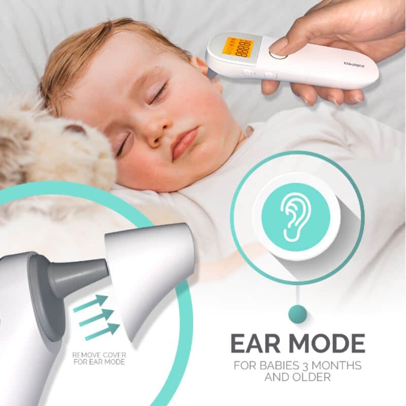 Baby Womb World 3-in-1 thermometer in ear mode, measuring temperature of a sleeping baby on a soft blanket.