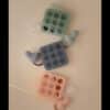 Mushie Fresh Food Feeder Freezer Tray in blush, Cambridge blue, and Tradewinds, featuring silicone trays and feeders.
