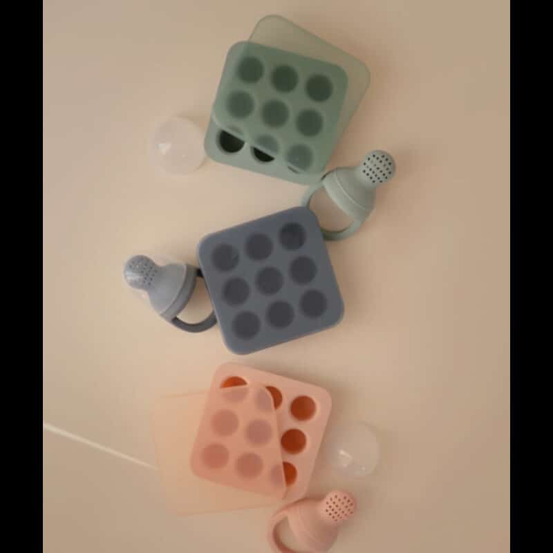 Mushie Fresh Food Feeder Freezer Tray in blush, Cambridge blue, and Tradewinds, featuring silicone trays and feeders.