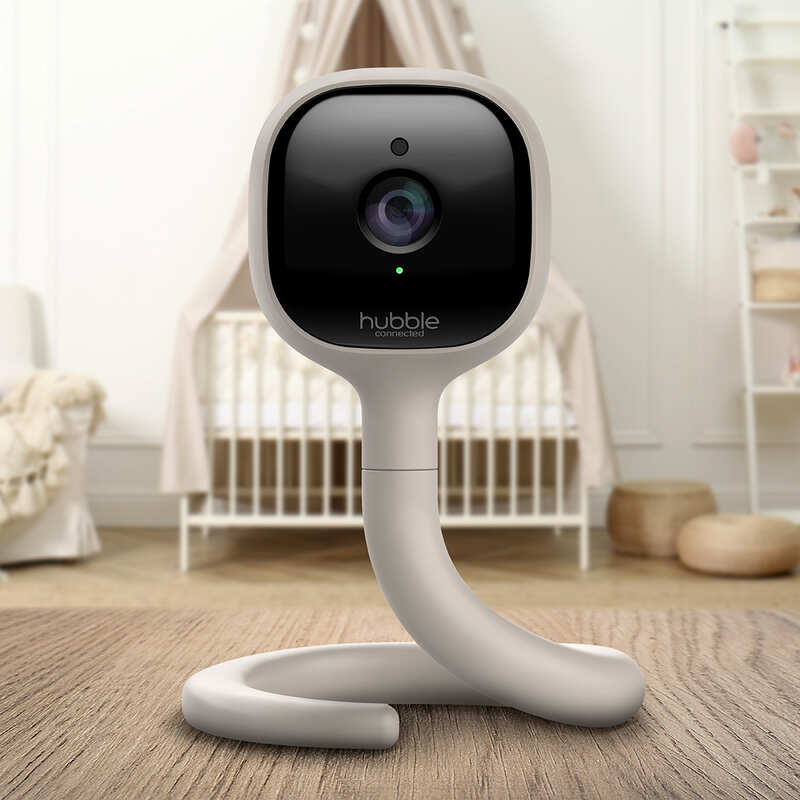 Hubble AI Vision security camera in light gray, featuring a flexible base, positioned in a nursery setting.
