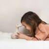 Flow Amsterdam Night Light featuring Liva character, a soft beige duck, with a child joyfully interacting in a cozy setting.