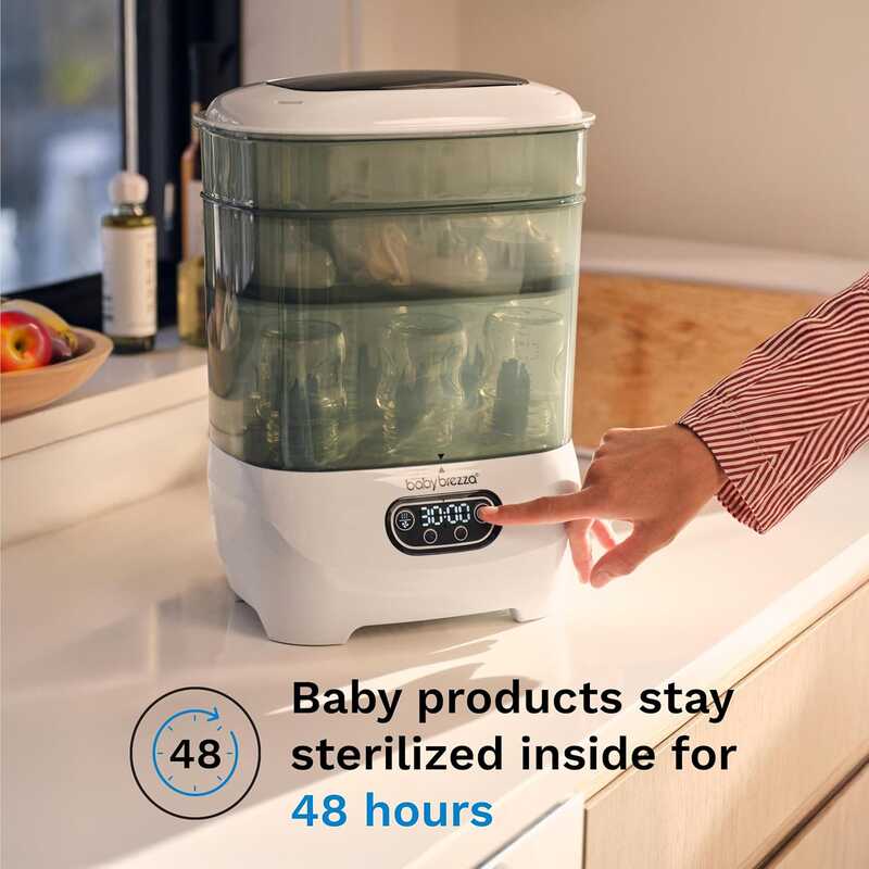 Baby Brezza Steriliser Dryer Advanced in a modern kitchen setting, showing a hand adjusting the timer for sterilization.
