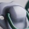 Tommee Tippee Moda Soother 6-18M 2Pk in gray and green, featuring a smooth, rounded nipple design for comfort.