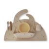 Mushie Stage 1 Feeding Bundle in neutral tones featuring a bib, bowl, cup, and two spoons with a playful design.
