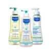 Mustela Stelatopia Bundle featuring cleansing oil, cleansing gel, and cream, all in pump bottles with colorful labels.