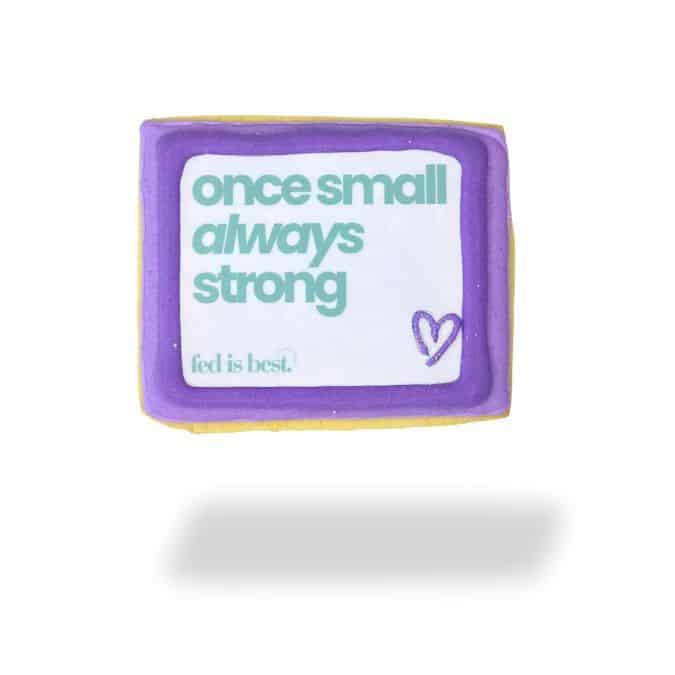 Whisked Bakery cookie featuring a purple and yellow design with the text "once small always strong" and a heart.