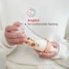 Pigeon Flexible Curved Bottle 250ml in Beach color, held by a person, showcasing its angled design for comfortable feeding.