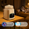 Momcozy KleanPal Pro Baby Bottle Washer, sterilizer, and dryer on a table, with a woman relaxing in the background.