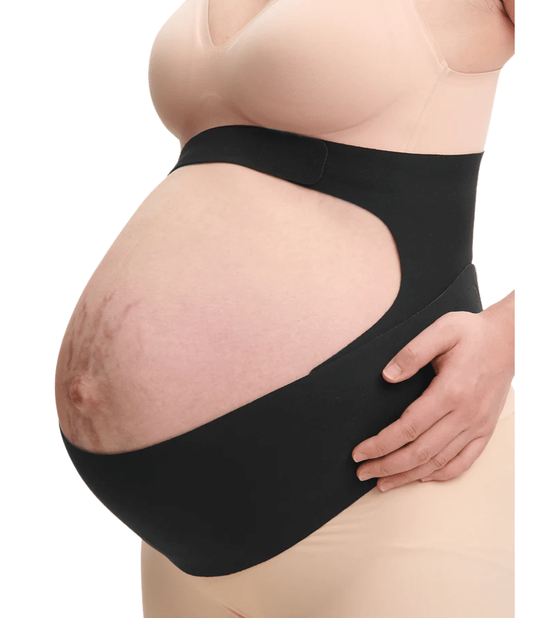 Momcozy Pregnancy Belly Band in black, worn by a pregnant woman, providing support with a cut-out design for comfort.