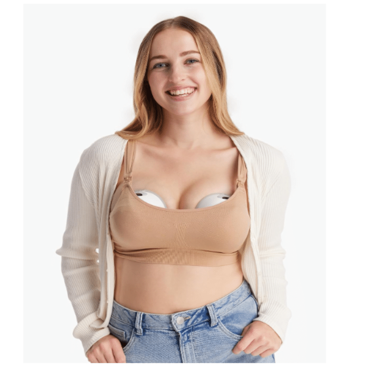 Momcozy Wearable Electric Breast Pump M5 in Cozy Red, worn hands-free under a cardigan, showing discreet design and comfort.