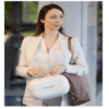 Momcozy Wearable Electric Breast Pump M5 in Cozy Red, shown in lifestyle setting with a woman carrying it in a stylish bag.