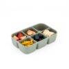 Maccie sage green snackle box with six compartments filled with fruits and snacks, set against a white background.