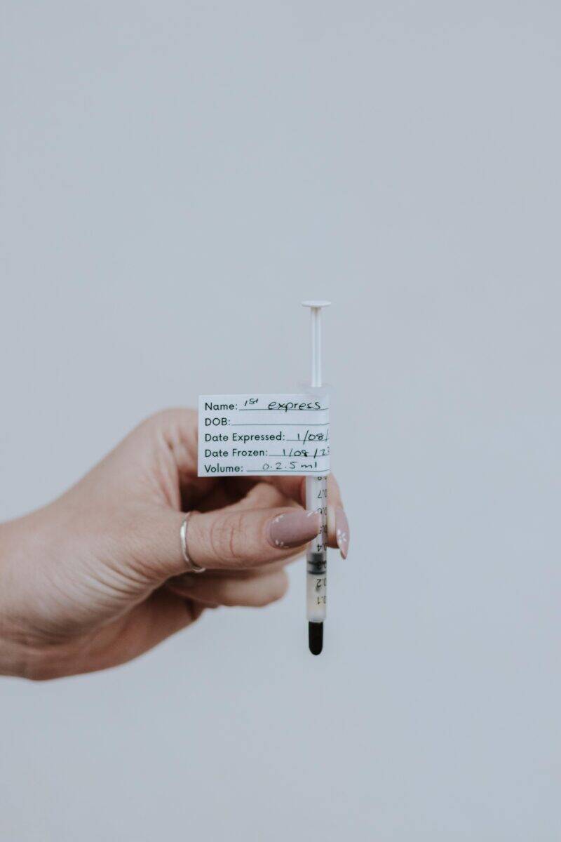 Beige and leopard print colostrum collection kit by Made to Lactate, featuring a syringe with a label for tracking.