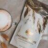 Made to Lactate Lactation Latté in a stylish bag with gold leaf design, placed beside a latte in a glass cup.