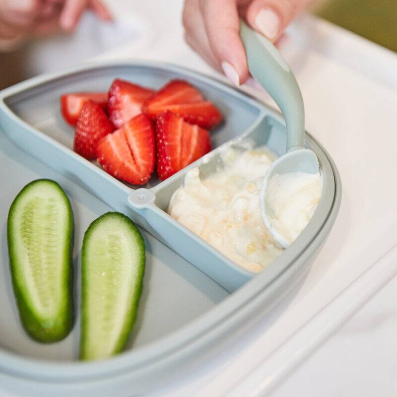b.box silicone plate in Ocean with three compartments, featuring strawberries, cucumber slices, and yogurt.