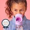 b.box 600ml Tritan drink bottle in pink, being used by a child, showcasing the unique sippy spout design.