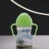 b.box Sippy Cup in Glow in the Dark with green lid and handles, featuring a clear body and straw for easy drinking.
